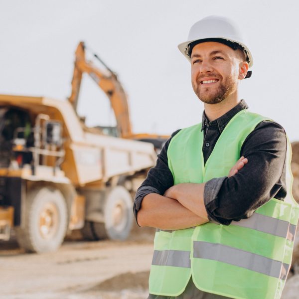 Male worker with bulldozer in sand quarry